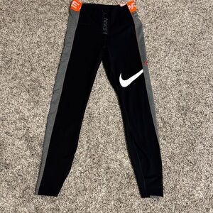 Nike Women’s Dri-fit leggings . Black and grey with orange accents.